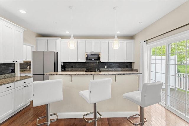 5 Manor Dr Unit B, Hooksett, NH 03106 - kitchen featuring appliances with stainless steel finishes, tasteful backsplash, white cabinets, dark wood-type flooring, and recessed lighting