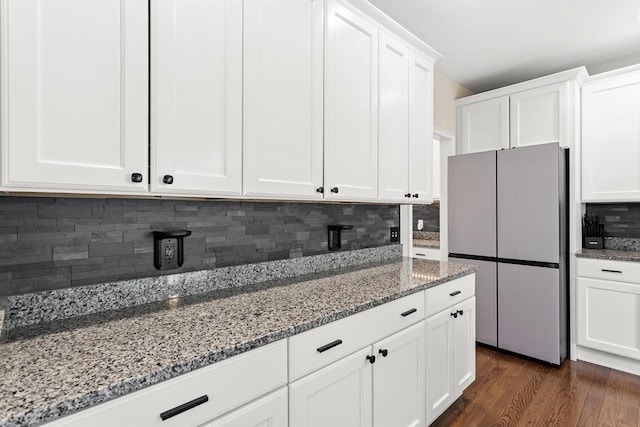 5 Manor Dr Unit B, Hooksett, NH 03106 - kitchen with freestanding refrigerator, stone countertops, tasteful backsplash, and white cabinets