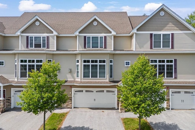 5 Manor Dr Unit B, Hooksett, NH 03106 - townhome / multi-family property with stone siding, a garage, driveway, and a shingled roof