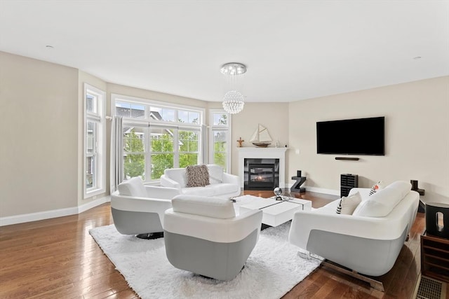 5 Manor Dr Unit B, Hooksett, NH 03106 - living area with hardwood / wood-style floors, baseboards, a glass covered fireplace, and a chandelier
