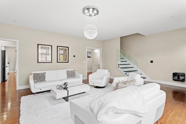 5 Manor Dr Unit B, Hooksett, NH 03106 - living room featuring wood finished floors, baseboards, a chandelier, and stairway
