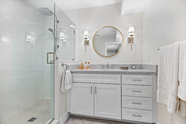 full bathroom featuring vanity, marble finish floor, and a stall shower