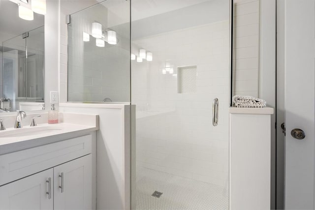 bathroom featuring a shower stall and vanity