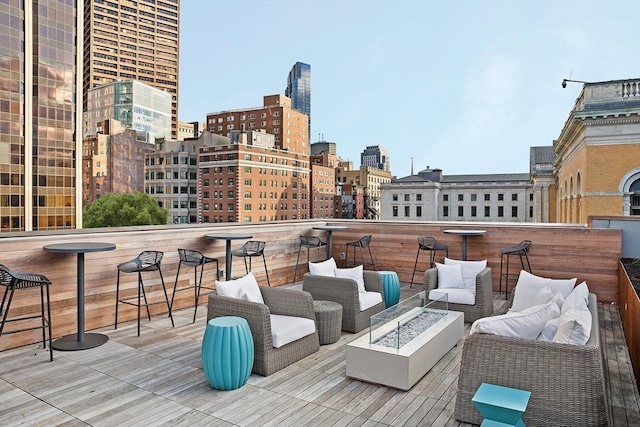 deck featuring a bar and an outdoor living space with a fire pit