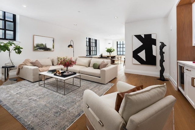 living room with hardwood / wood-style flooring and beverage cooler