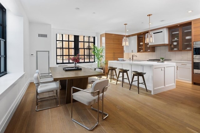 dining space featuring sink and light wood-type flooring