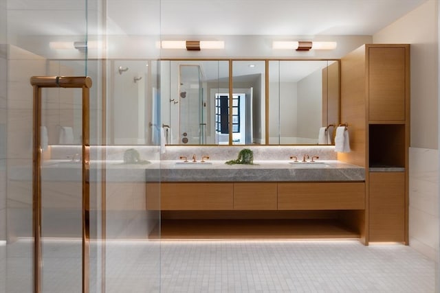 bathroom featuring a shower with door, tile patterned floors, and vanity