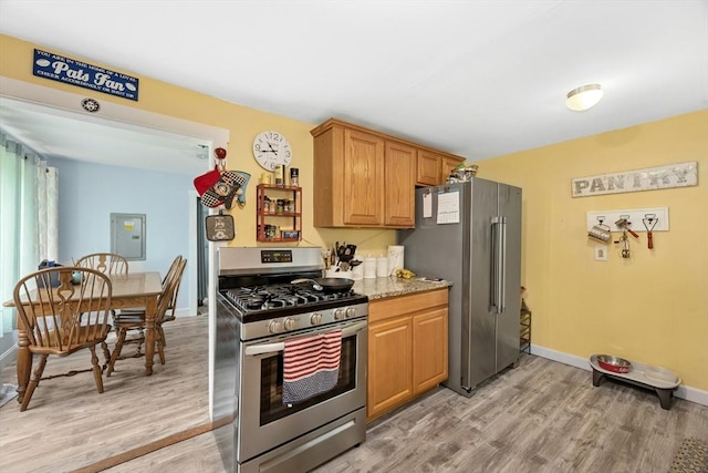 8 Stones Corner Rd, Berlin, MA 01503 - kitchen featuring stainless steel appliances, light wood-style floors, and light stone countertops