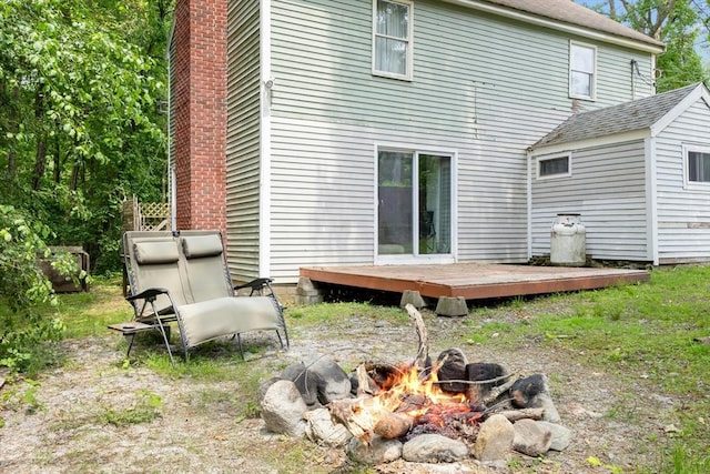 8 Stones Corner Rd, Berlin, MA 01503 - back of house featuring a fire pit, a wooden deck, and a chimney