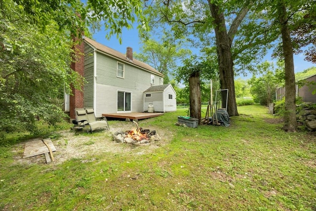 8 Stones Corner Rd, Berlin, MA 01503 - rear view of house featuring a fire pit, a chimney, a yard, and a deck