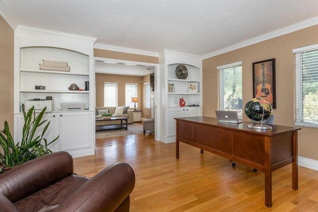 office area featuring crown molding, a wealth of natural light, and light wood-style floors