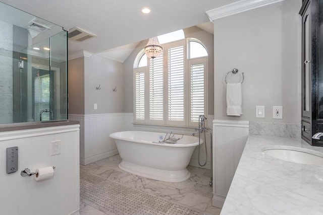 bathroom with a freestanding tub, visible vents, marble finish floor, and a wainscoted wall