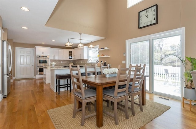dining area with recessed lighting, light wood-style flooring, and visible vents