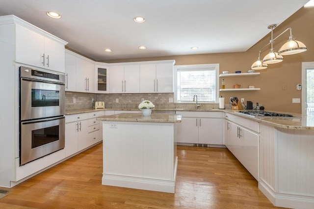 kitchen featuring white cabinetry, appliances with stainless steel finishes, and backsplash