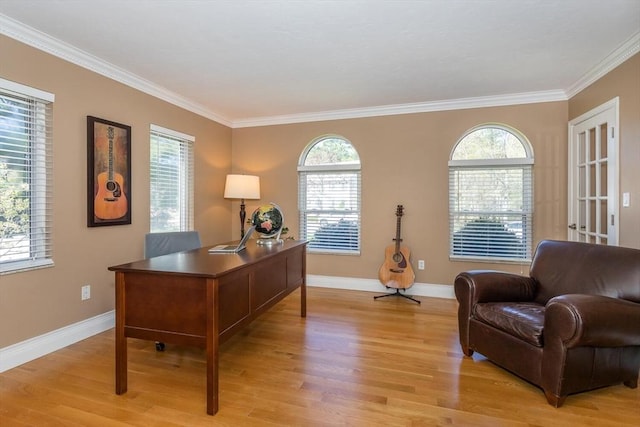 office area featuring baseboards, ornamental molding, and light wood-style flooring
