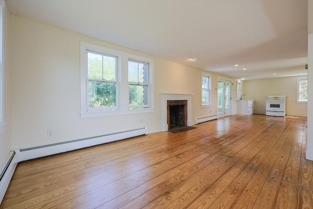 460 W Main Rd, Little Compton, RI 02837 - unfurnished living room with a baseboard heating unit, a fireplace, hardwood / wood-style floors, and recessed lighting