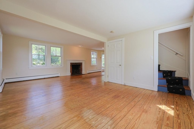460 W Main Rd, Little Compton, RI 02837 - unfurnished living room with light wood finished floors, healthy amount of natural light, a brick fireplace, and baseboard heating