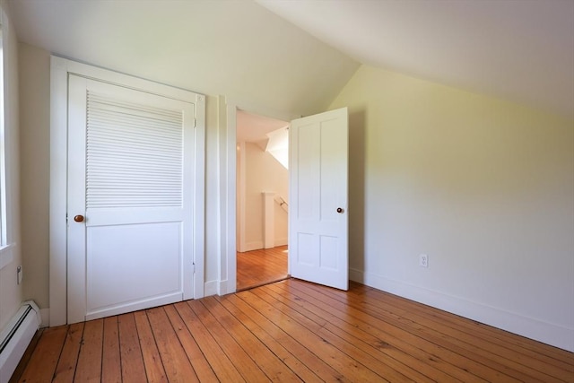 460 W Main Rd, Little Compton, RI 02837 - unfurnished bedroom featuring baseboard heating, light wood-style floors, lofted ceiling, baseboards, and a closet