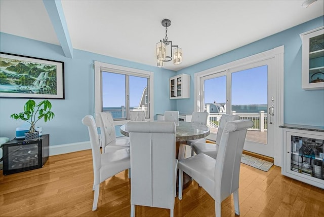75 Point Allerton Ave, Hull, MA 02045 - dining space featuring light wood-type flooring, a chandelier, and baseboards