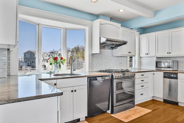 75 Point Allerton Ave, Hull, MA 02045 - kitchen with appliances with stainless steel finishes, a sink, dark stone countertops, white cabinets, and beam ceiling