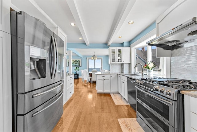 75 Point Allerton Ave, Hull, MA 02045 - kitchen with stainless steel appliances, white cabinets, backsplash, light wood-style floors, and glass insert cabinets