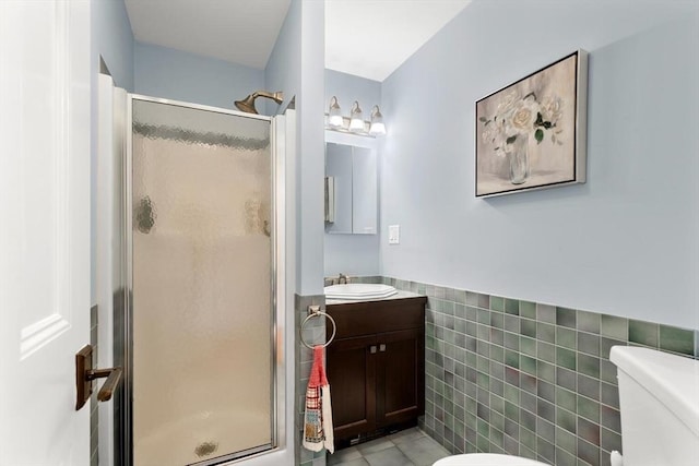 75 Point Allerton Ave, Hull, MA 02045 - bathroom with tile walls, toilet, a stall shower, wainscoting, and vanity