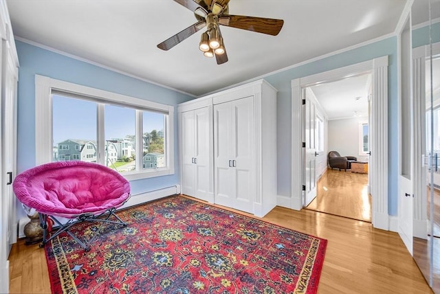 75 Point Allerton Ave, Hull, MA 02045 - sitting room with crown molding, healthy amount of natural light, light wood-type flooring, a ceiling fan, and baseboard heating