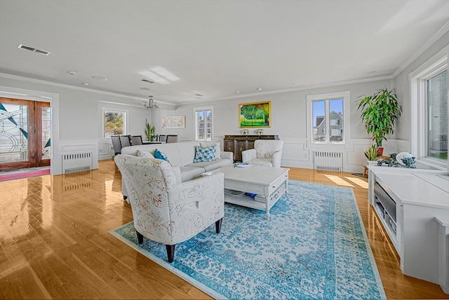 75 Point Allerton Ave, Hull, MA 02045 - living area with radiator, ornamental molding, light wood finished floors, a wainscoted wall, and a decorative wall