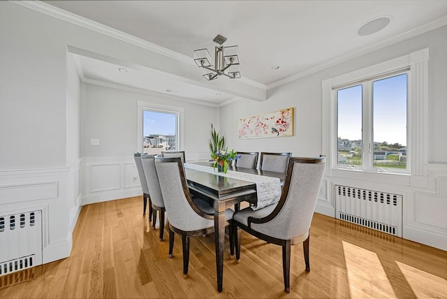75 Point Allerton Ave, Hull, MA 02045 - dining space with radiator, a chandelier, light wood finished floors, ornamental molding, and wainscoting