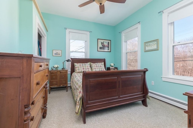 bedroom featuring light carpet, a ceiling fan, and a baseboard radiator