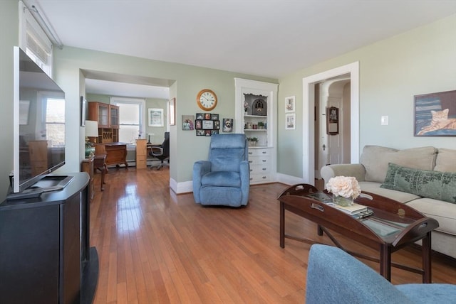 living room with baseboards and wood-type flooring