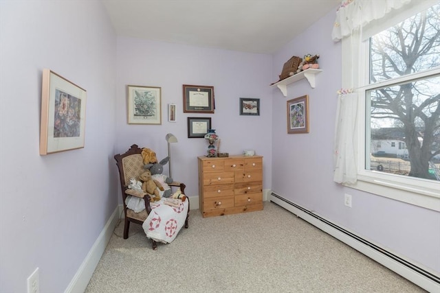 living area featuring a baseboard heating unit, baseboards, and carpet flooring