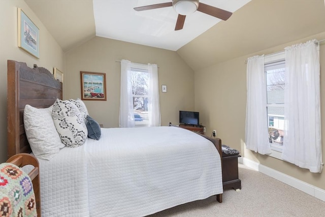 carpeted bedroom featuring vaulted ceiling, baseboards, and ceiling fan