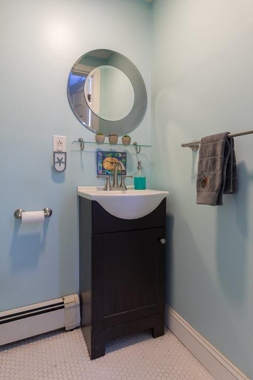 bathroom with vanity, baseboards, and a baseboard radiator