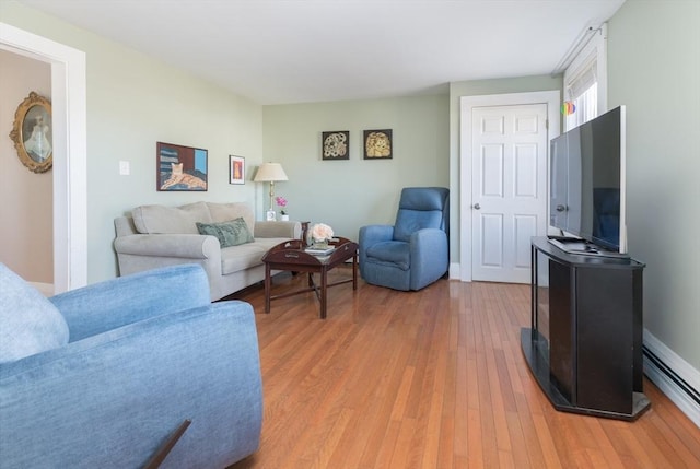 living room featuring baseboards and light wood finished floors