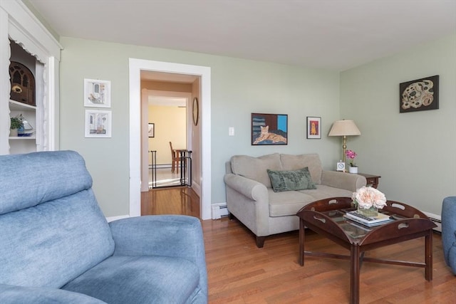 living room featuring wood finished floors and baseboard heating