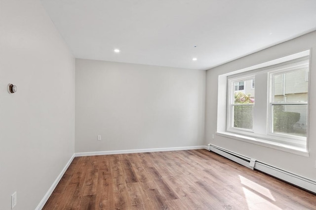 2 Howe Ter Unit 11, Boston, MA 02125 - spare room featuring a baseboard radiator, wood finished floors, baseboards, and recessed lighting
