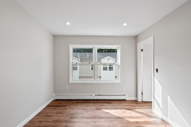 2 Howe Ter Unit 11, Boston, MA 02125 - empty room featuring wood finished floors, a baseboard heating unit, recessed lighting, and baseboards