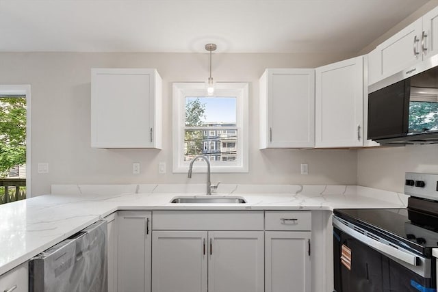 2 Howe Ter Unit 11, Boston, MA 02125 - kitchen featuring appliances with stainless steel finishes, a sink, white cabinets, light stone countertops, and hanging light fixtures