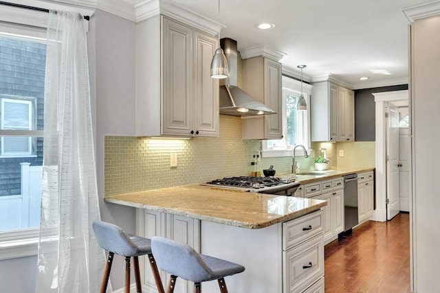 42 Sylvia Rd Unit 42, Medford, MA 02155 - kitchen with a sink, wall chimney range hood, a peninsula, light stone countertops, and a kitchen bar