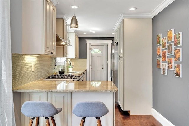 42 Sylvia Rd Unit 42, Medford, MA 02155 - kitchen with a peninsula, crown molding, light stone countertops, a kitchen breakfast bar, and decorative backsplash