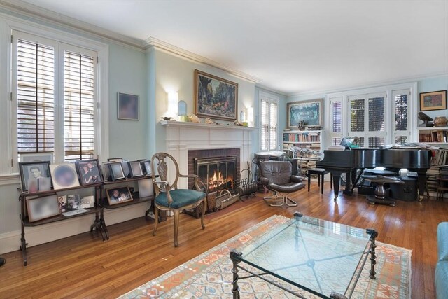 46 Central Ave, Newton, MA 02460 - living area with baseboards, ornamental molding, wood finished floors, and a brick fireplace