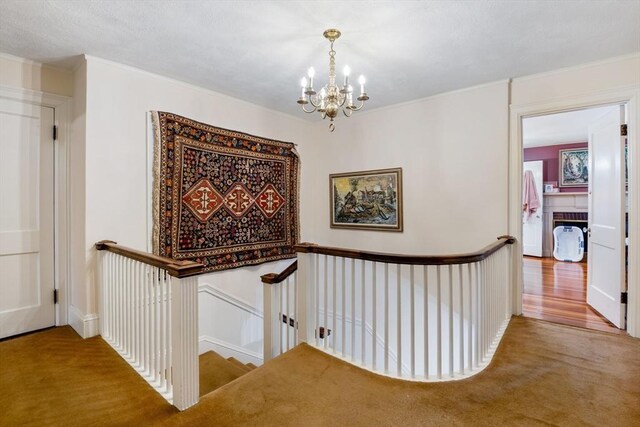 46 Central Ave, Newton, MA 02460 - corridor featuring an upstairs landing, carpet floors, and a chandelier
