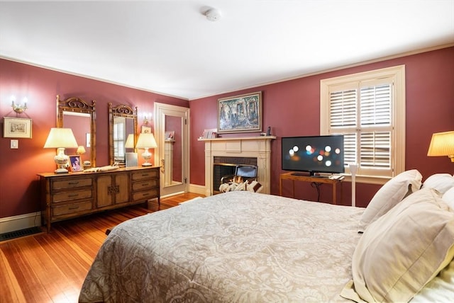 46 Central Ave, Newton, MA 02460 - bedroom with baseboards, wood finished floors, and a glass covered fireplace