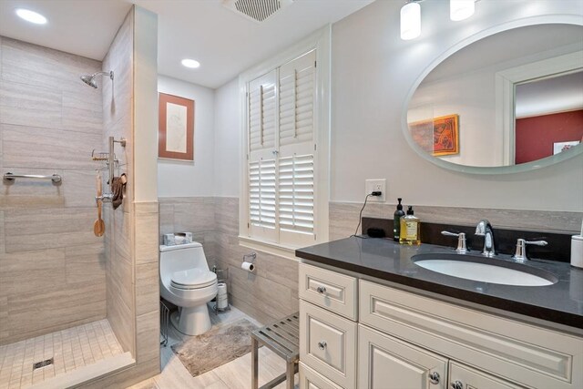 46 Central Ave, Newton, MA 02460 - bathroom featuring vanity, tile walls, a tile shower, toilet, and visible vents