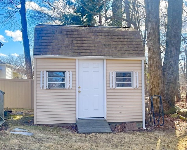 view of shed featuring fence