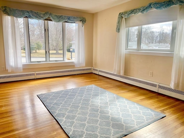 interior space featuring hardwood / wood-style floors and baseboard heating