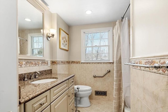 full bathroom featuring visible vents, tile walls, toilet, tile patterned floors, and vanity