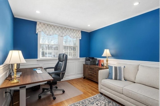 office space featuring recessed lighting, a wainscoted wall, wood finished floors, and ornamental molding