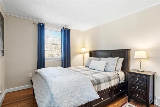 bedroom featuring visible vents, baseboards, light wood-type flooring, and ornamental molding